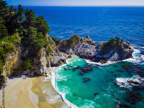 Aerial view of Water Fall McWay Falls Julia Pfeiffer Burns Park Big Sur California. McWay Falls a waterfall empties directly into the ocean.