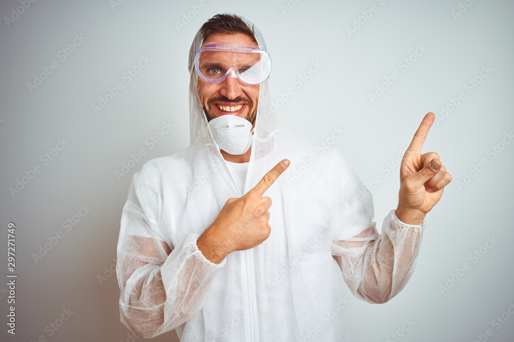 Painter man wearing professional worker equipment protection over isolated background smiling and looking at the camera pointing with two hands and fingers to the side. Painter man wearing professional worker equipment protection over isolated background smiling and looking at the camera pointing with two hands and fingers to the side.