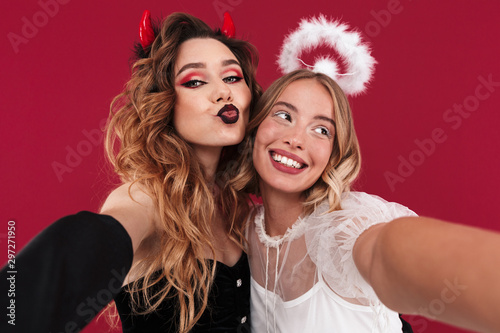 Women angel and demon in carnival costumes