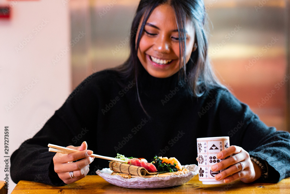 asian girl eating in the japanese restaurant asian girl eating in the japanese restaurant