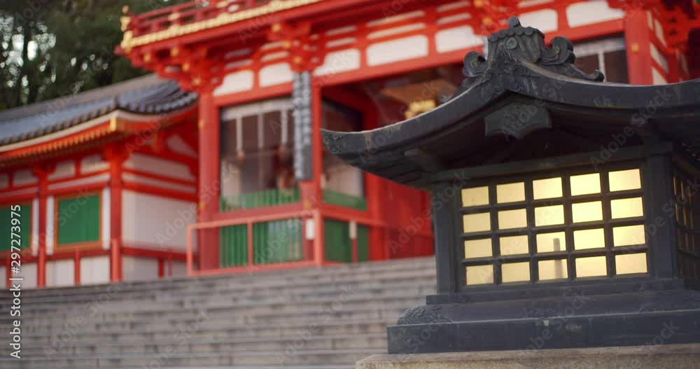 Wooden lantern panning to a beautiful red shrine early morning in Kyoto, Japan soft lighting Wooden lantern panning to a beautiful red shrine early morning in Kyoto, Japan soft lighting