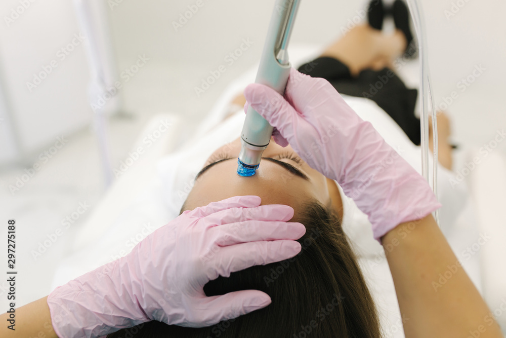 First-person view of cosmetologist doing beauty procedure at cosmetology clinic First-person view of cosmetologist doing beauty procedure at cosmetology clinic