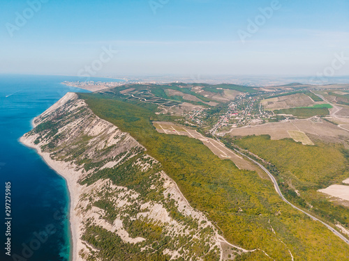 Coastline with cliff, forest, road and blue sea in Anapa. Aerial view