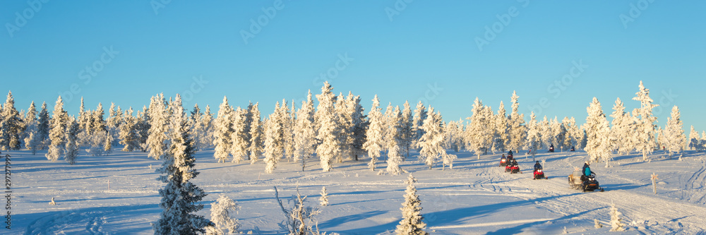 Group of snowmobiles in Lapland, near Saariselka, panoramic winter background, Finland Group of snowmobiles in Lapland, near Saariselka, panoramic winter background, Finland