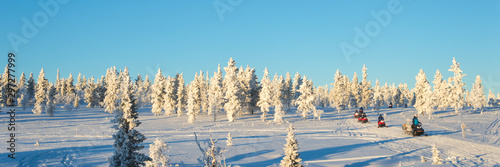 Billede på lærred Group of snowmobiles in Lapland, near Saariselka, panoramic winter background, F