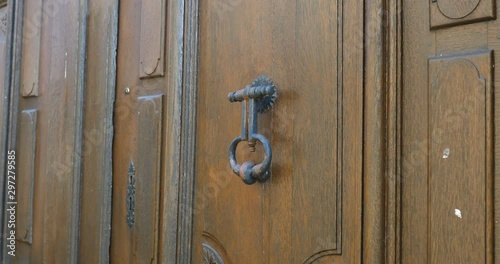 Old medieval door knocker on wooden old heritage door in Loire valley, Le lude, France 27/2/19 photo