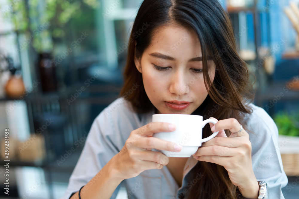 Asian woman working and drink coffee in cafe with laptop computer smile and happy work Asian woman working and drink coffee in cafe with laptop computer smile and happy work