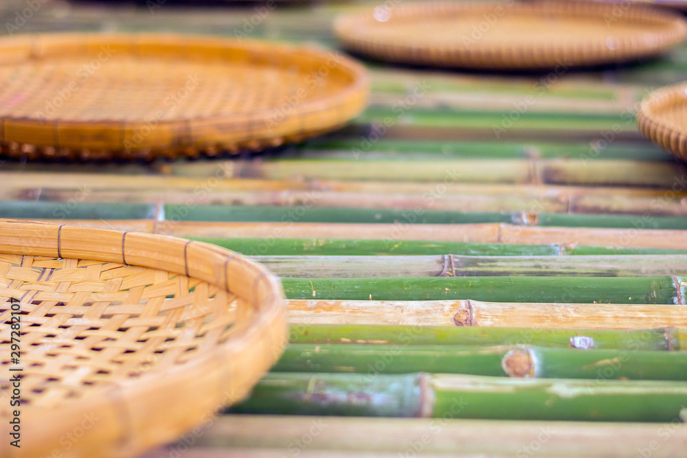 Obraz premium handmade thai basket on bamboo poles