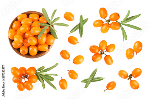 Sea buckthorn in wooden bowl. Fresh ripe berry with leaves isolated on white background. Top view. Flat lay pattern