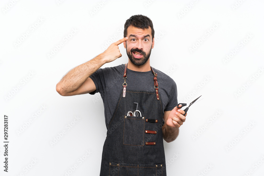 Barber man in an apron making the gesture of madness putting finger on the head Barber man in an apron making the gesture of madness putting finger on the head