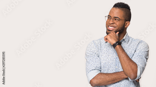 Smiling african American man look at blank copy space