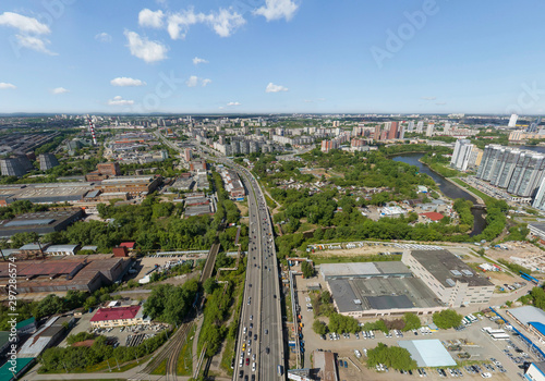 Summer city, road with cars and Industrial Zone, a lot of trees, aerial view. Ekaterinburg, Verkh-Isetsky district, Russia