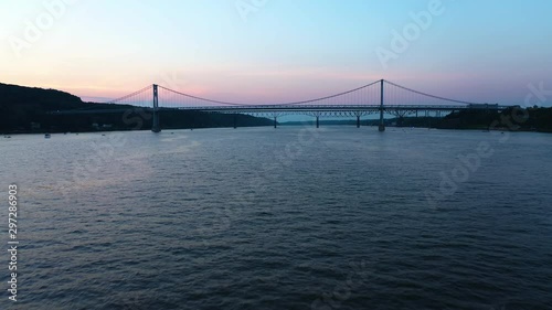 Low aerial over Hudson River towards Mid Hudson Bridge, Poughkeepsie, NY at dusk