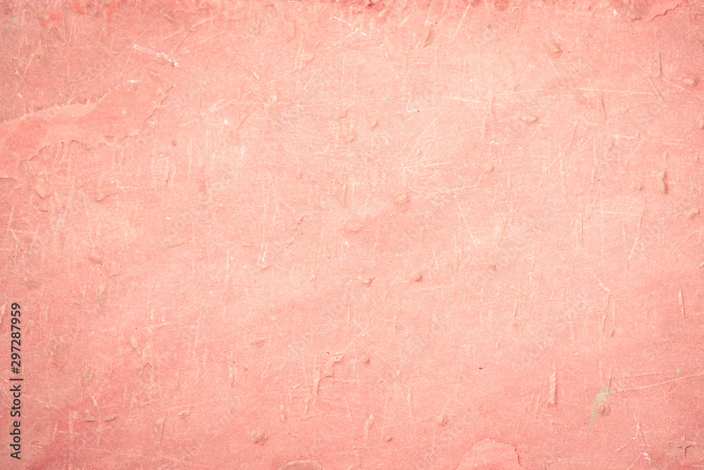 Pink orange concrete wall with small dimples. the mood is swampy. warm tone. Horizontal orientation.