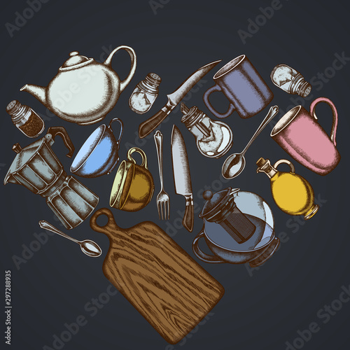 Heart floral design on dark background with Chef's knifes, teaspoon, spoon, fork, knife, cutting board, bottle of oil, teapots, coffee pot, cups, sugar bowl, pepper shaker, salt shaker