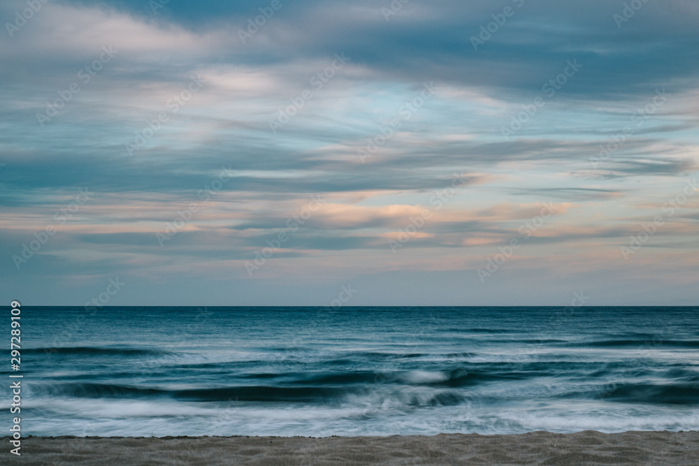 Long exposure photography of the sea with clouds at sunset