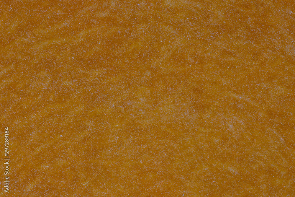 Yellow pumpkin cut in half with the texture of pulp. Pumpkin slices background closeup, top view