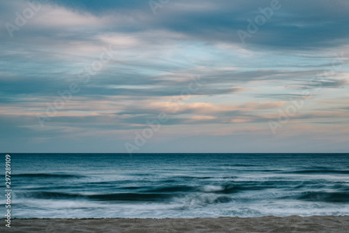 Long exposure photography of the sea with clouds at sunset