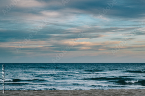 Photograph of the sea with clouds at sunset