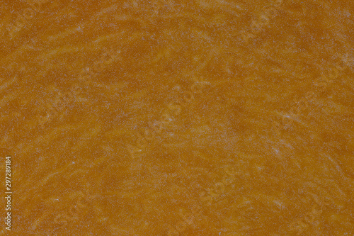 Yellow pumpkin cut in half with the texture of pulp. Pumpkin slices background closeup, top view