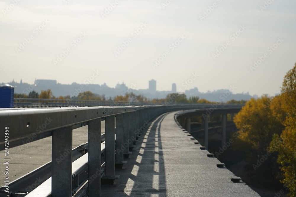 Unfinished bridge against the background of the silhouette of the city. Unfinished highway away city. Fender on the autobahn Unfinished bridge against the background of the silhouette of the city. Unfinished highway away city. Fender on the autobahn