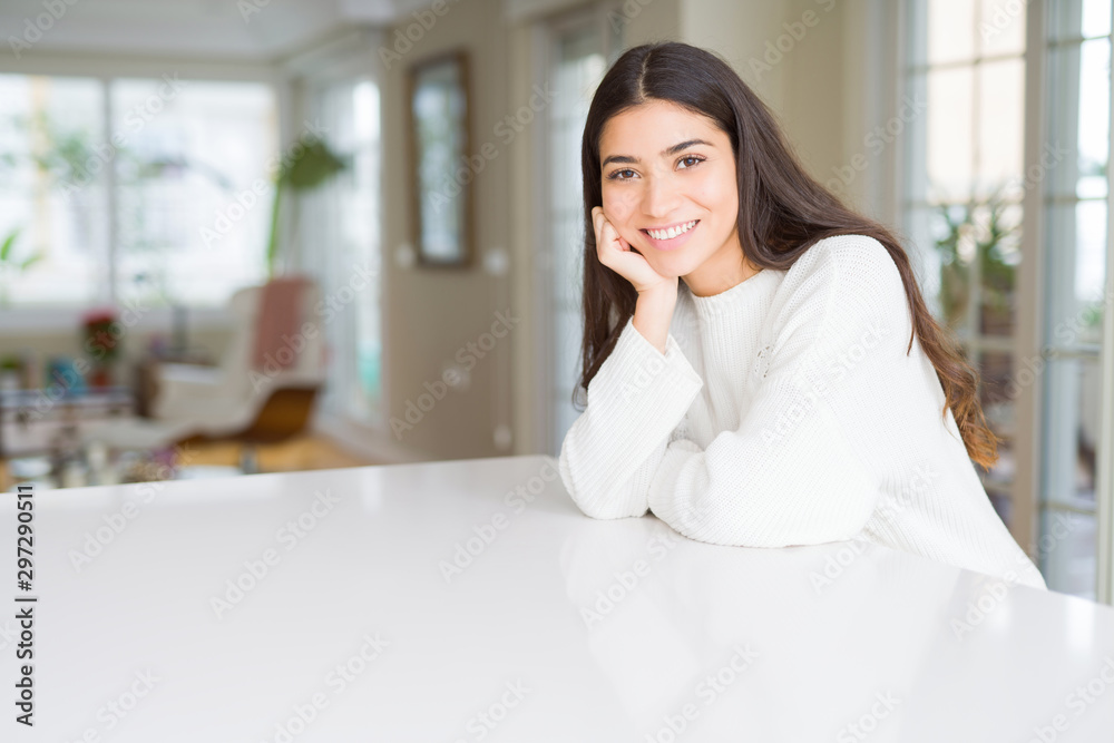 Beautiful brunette woman smiling cheerful with big smile, looking positive and happy with crossed arms