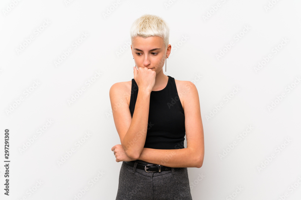 Teenager girl with short hair over white wall having doubts Teenager girl with short hair over white wall having doubts
