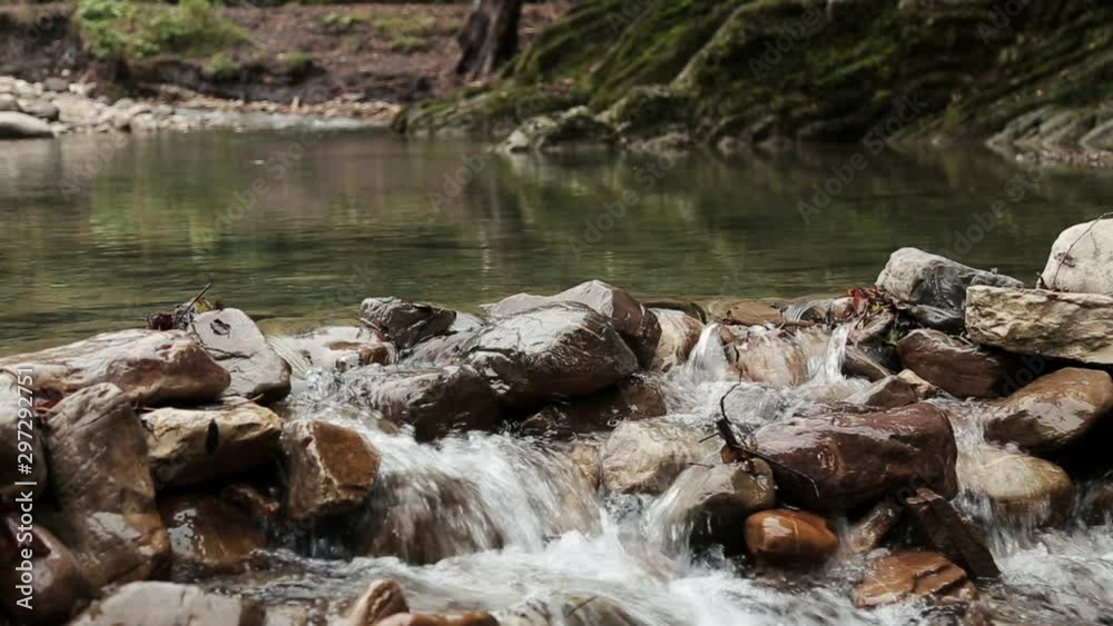 A small lake made of Ribera stones for three months. Mountain landscape of the river valley. Mountain river, valley stream. River valley in the mountains . stones a small river. A small lake made of Ribera stones for three months. Mountain landscape of the river valley. Mountain river, valley stream. River valley in the mountains . stones a small river.