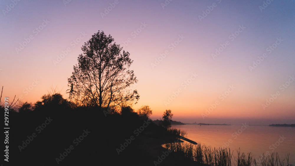 a sunset over the river