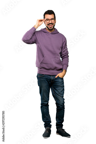 Full-length shot of Handsome man with sweatshirt with glasses and surprised over isolated white background