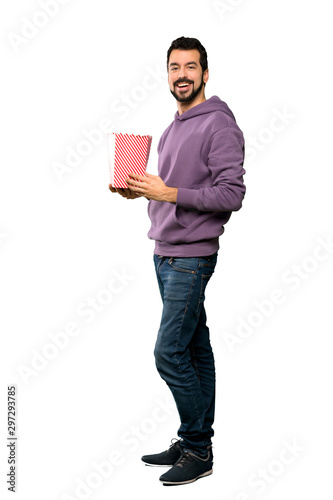 Handsome man with sweatshirt eating popcorns