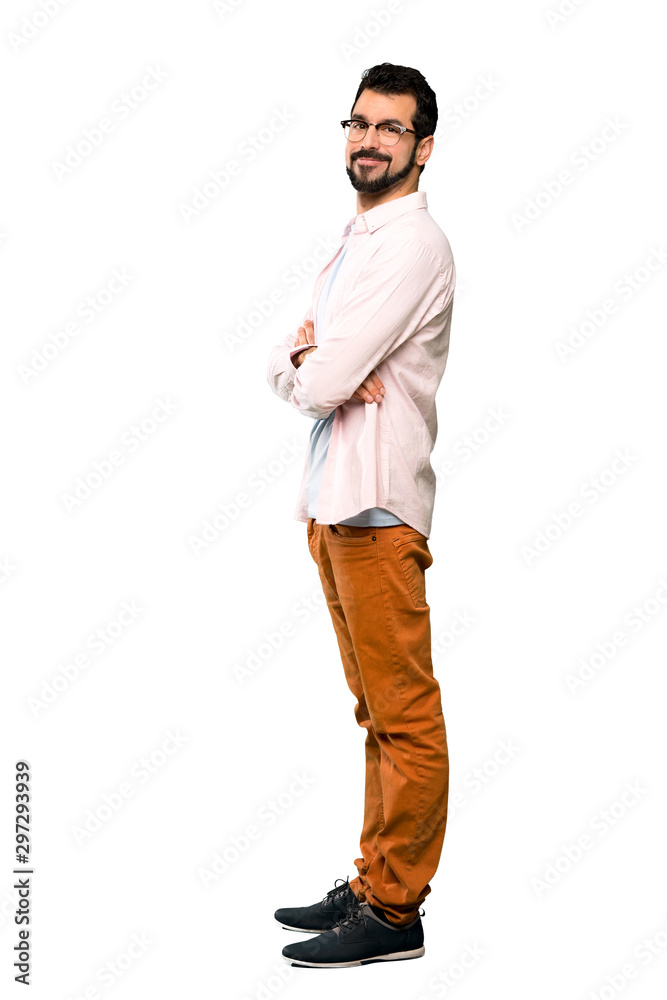 Full-length shot of Handsome man with beard with arms crossed and looking forward over isolated white background Full-length shot of Handsome man with beard with arms crossed and looking forward over isolated white background