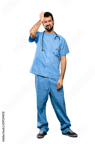 Full-length shot of Surgeon doctor man with an expression of frustration and not understanding over isolated white background © luismolinero