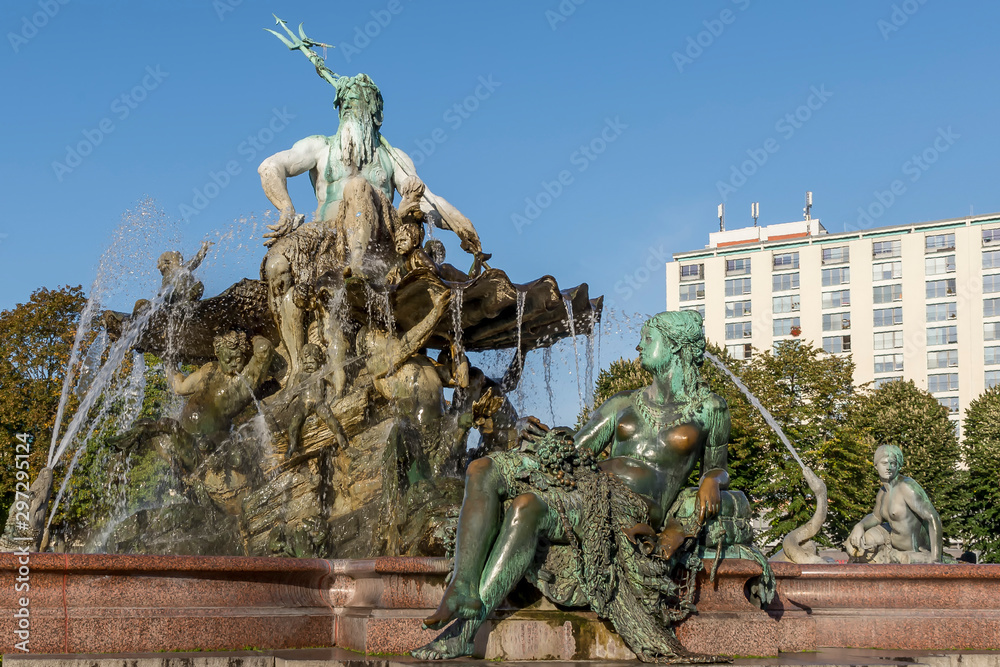 The beautiful Neptune Fountain, in German Neptunbrunnen, illuminated by the morning sun, Berlin, Germany