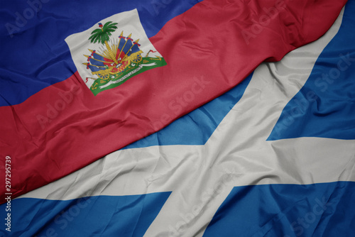 Obraz na płótnie waving colorful flag of scotland and national flag of haiti.