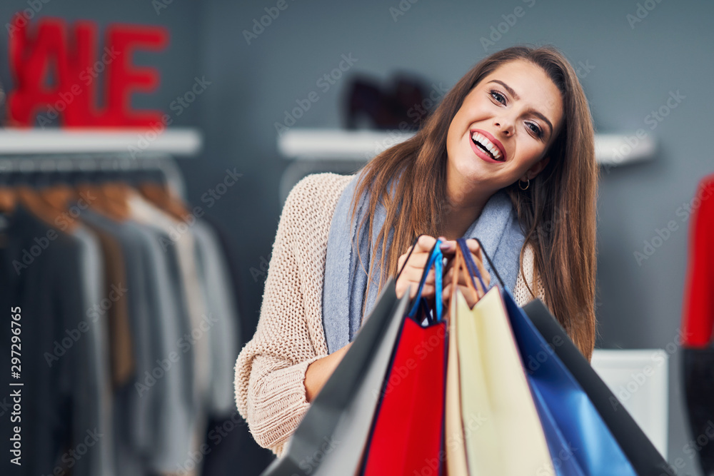 Adult women shopping for clothes in boutique in autumn