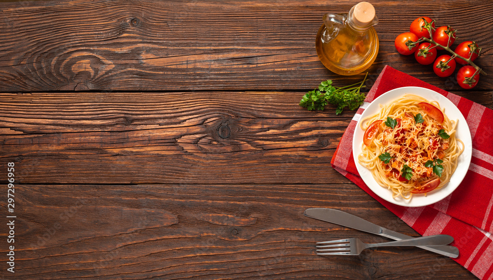 Pasta carbonara with tomato sauce and minced meat, grated parmesan cheese and fresh parsley - homemade healthy italian pasta on rustic wooden background. Flat lay. Top view.
