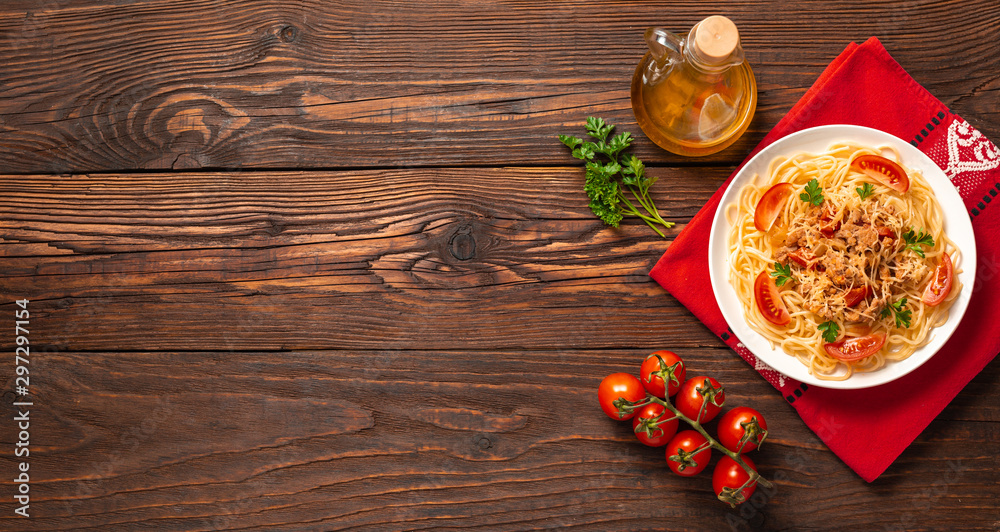 Pasta bolognese with tomato sauce and minced meat, grated parmesan cheese and fresh parsley - homemade healthy italian pasta on rustic wooden background. Flat lay. Top view. Pasta bolognese with tomato sauce and minced meat, grated parmesan cheese and fresh parsley - homemade healthy italian pasta on rustic wooden background. Flat lay. Top view.