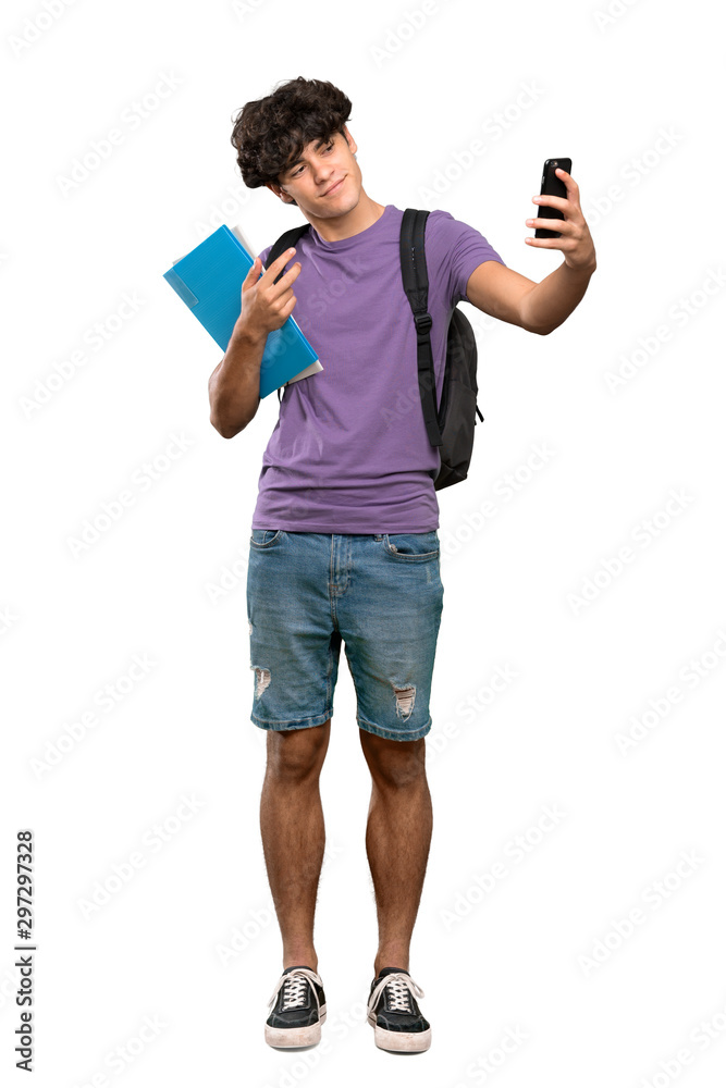 A full-length shot of a Young student man making a selfie over isolated white background A full-length shot of a Young student man making a selfie over isolated white background