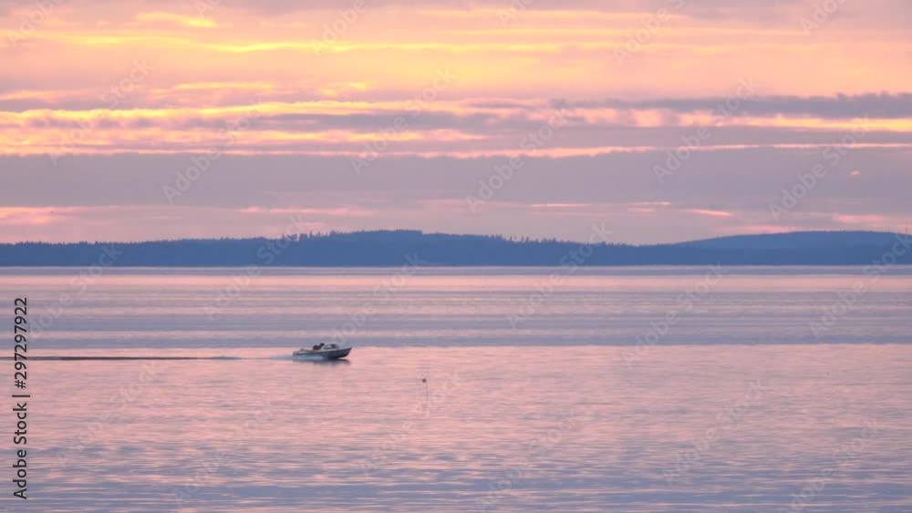 Lake and boat at sunset, Sweden. Tranquil and peaceful nature scene with beautiful scenic landscape.