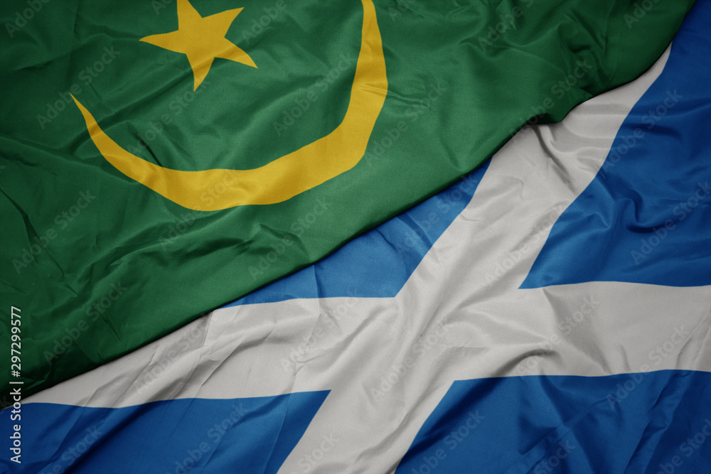 waving colorful flag of scotland and national flag of mauritania.