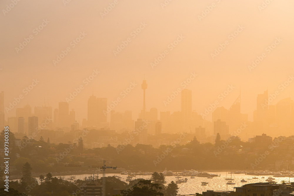 Foggy Sydney skyline under the warm sunlight.