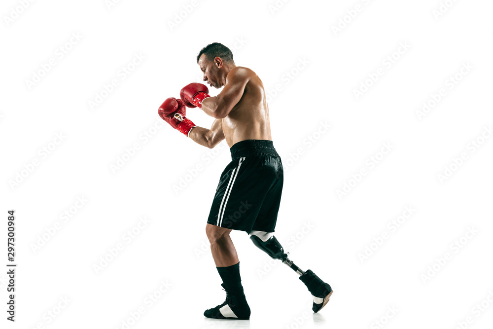 Full length portrait of muscular sportsman with prosthetic leg, copy space. Male boxer in red gloves. Isolated shot on white studio background. Full length portrait of muscular sportsman with prosthetic leg, copy space. Male boxer in red gloves. Isolated shot on white studio background.