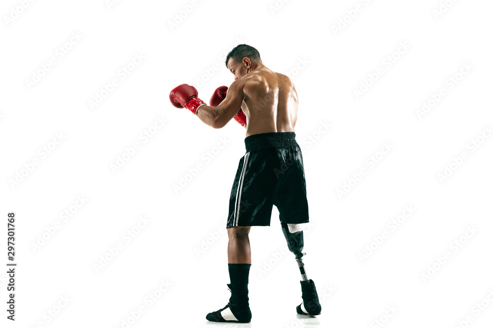 Full length portrait of muscular sportsman with prosthetic leg, copy space. Male boxer in red gloves. Isolated shot on white studio background. Full length portrait of muscular sportsman with prosthetic leg, copy space. Male boxer in red gloves. Isolated shot on white studio background.
