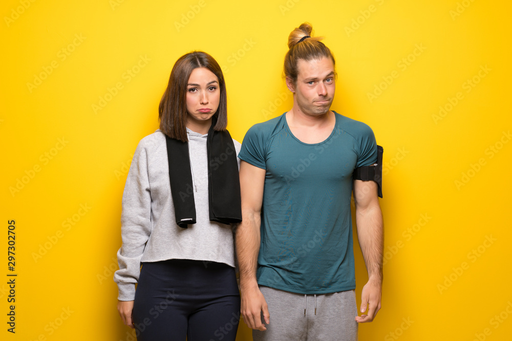 Group of athletes over yellow background with sad and depressed expression Group of athletes over yellow background with sad and depressed expression