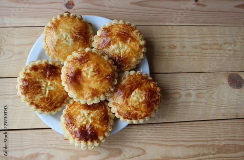 Flat lay view of a plate of freshly baked 'Mattentaart', a gastronic speciality of the Geraardsbergen region of Belgium. With copy space. photo