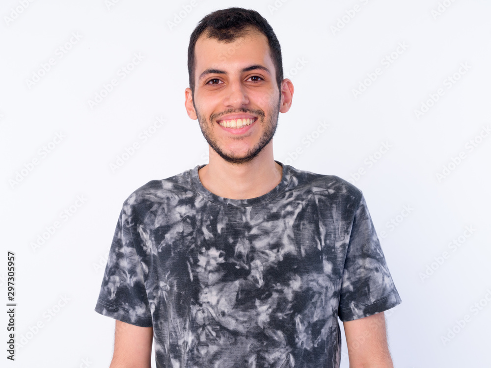 Face of happy young bearded Persian man smiling Face of happy young bearded Persian man smiling