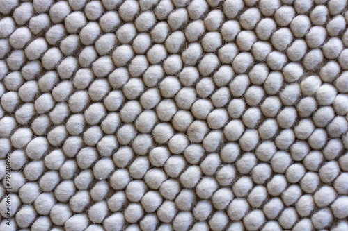 Texture of warm woolen white rug   bee honeycomb pattern  soft focus.