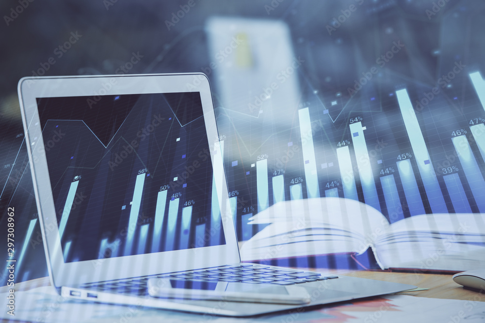 Forex graph hologram on table with computer background. Double exposure. Concept of financial markets. Forex graph hologram on table with computer background. Double exposure. Concept of financial markets.