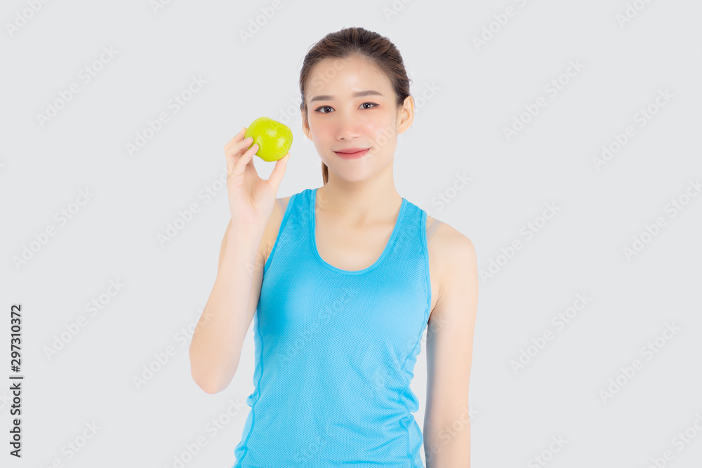 Beautiful portrait young asian woman in sport clothing with satisfied and holding green apple isolated on white background, girl asia have shape and wellness, exercise for fit with health concept.